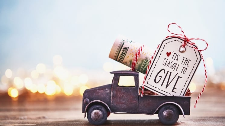 season-to-give-truck-carrying-roll-of-dollars-with-holiday-background-picture-id1166729754 FB